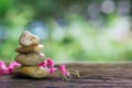 Balance Zen stones and pink flower on wood with green bokeh back Royalty Free Stock Photo