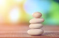 Balance Zen stones on wood with green nature bokeh background Royalty Free Stock Photo