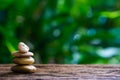 Balance Zen stones on wood with green nature bokeh background. Royalty Free Stock Photo