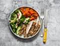 Balanced diet food - grilled turkey sweet potatoes kale cabbage avocado cucumbers radish salad on a grey background top view