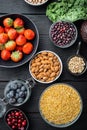 Balanced diet organic healthy food clean eating selection, flat lay, on black wooden background