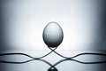 Balanced egg on two forks. Royalty Free Stock Photo