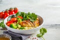 Balanced food concept. Chicken, broccoli and quinoa salad in white bowl, gray background, copy space