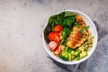 Balanced food concept. Chicken, broccoli and quinoa salad in white bowl, gray background, top view