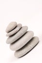 Balanced grey stones over white background Royalty Free Stock Photo