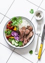 Balanced lunch - grilled beef steak, vegetables and rice on a light background, top view Royalty Free Stock Photo