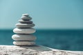 Balanced pebble pyramid on the beach on a sunny day. Abstract Sea bokeh on the background. Selective focus. Zen stones Royalty Free Stock Photo