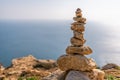 Balanced pebble pyramid silhouette on the beach. Abstract warm sunset bokeh with Sea on the background. Zen stones on Royalty Free Stock Photo