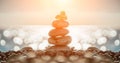 Balanced pebbles pyramid on the beach on sunny day and clear sky at sunset. Blue sea on background. Selective focus, bokeh. Zen Royalty Free Stock Photo