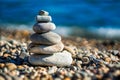 Balanced Pebbles Pyramid on the Beach on Sunny Day and Clear Sky at Sunset. Blue Sea on Background Selective focus, zen stones on Royalty Free Stock Photo