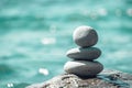 Balanced pebble pyramid on the beach on a sunny day. Abstract Sea bokeh on the background. Selective focus. Zen stones Royalty Free Stock Photo