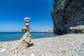 Balanced Pebbles Pyramid on the isolated Beach on Sunny Day and Clear Sky. Blue Sea on Background. Selective focus, Bokeh. Zen Royalty Free Stock Photo