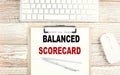 BALANCED SCORECARD text on clipboard on wooden background