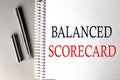 BALANCED SCORECARD text on a notebook with pen on grey background