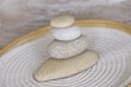 Balanced stack of smooth pebble in a bamboo bowl