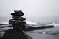 Balanced Stack of Stones by the Sea on Overcast Day Royalty Free Stock Photo