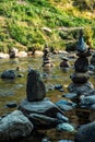 Balanced stones Zen rock stacks meditation art in flowing water of mountain stream Royalty Free Stock Photo