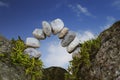 Balanced stone arch of pebbles as zen symbol for a bridge or a g