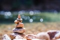 Balanced stone pyramide on shore On a stream of nature Blurred background bokeh