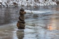 Balanced stone pyramid in the middle of the river Vilnia in Vilnius in winter. Lithuania Royalty Free Stock Photo