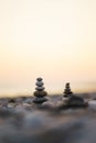 Balanced stone pyramid on pabbles beach with sunset. Zen rock, concept of balance and harmony Royalty Free Stock Photo