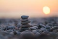 Balanced stone pyramid on pabbles beach with sunset. Zen rock, concept of balance and harmony Royalty Free Stock Photo