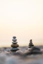 Balanced stone pyramid on pabbles beach with sunset. Zen rock, concept of balance and harmony Royalty Free Stock Photo