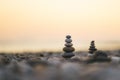 Balanced stone pyramid on pabbles beach with sunset. Zen rock, concept of balance and harmony Royalty Free Stock Photo