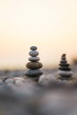 Balanced stone pyramid on pabbles beach with sunset. Zen rock, concept of balance and harmony Royalty Free Stock Photo