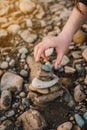 Balanced stone pyramide on shore of the ocean at dawn. Sea pebbles tower closeup symbolizing stability, zen, harmony, balance. Royalty Free Stock Photo