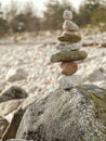Balance stones on a rock. Blurred bright background. Concept hard work, goal achievement, insistence, tenacity Royalty Free Stock Photo