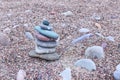 Balanced stones on sea beach. Sand on beach. Pyramid of pebbles. Harmony, balance and relax concept Royalty Free Stock Photo