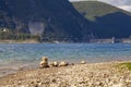 Tranquil scene at Lake Salto, featuring balanced stones and a distant dam Royalty Free Stock Photo