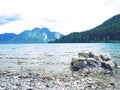 Balanced stones stacked in pyramid at lake water with Dolomite Alps reflection Royalty Free Stock Photo