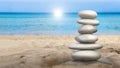 Balanced stones standing on the beach sand. 3D illustration