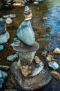 Balanced stones Zen rock stack meditation art in flowing water of mountain stream Royalty Free Stock Photo