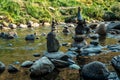 Balanced stones Zen rock stacks meditation art in flowing water of mountain stream Royalty Free Stock Photo