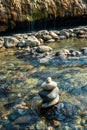 Balanced stones Zen rock stacks meditation art in flowing water of mountain stream Royalty Free Stock Photo