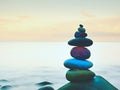 Balanced stones, Zen Stack in front of smooth ocean. A calming view from the terrace. Royalty Free Stock Photo