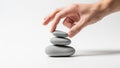 Balances three smooth gray stones stacked vertically on a white Royalty Free Stock Photo