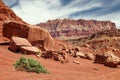 Balancing eroded boulders at the base of a red sandstone table in Vermilion Cliffs National Monument in northern Arizona, near the