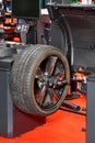 Balancing a car wheel at a service station, vertical image Royalty Free Stock Photo