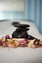 Hot stone massage. Balance. Rose petals