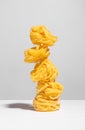 Balancing pasta in a stack with a shadow on a light background Royalty Free Stock Photo