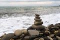 Balancing pyramid of sea stones on a pebble beach