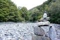 Balancing stone with river and mountain background