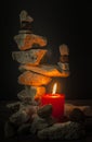 Balancing stones with a candle Royalty Free Stock Photo