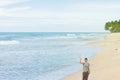 Balapitiya Beach, Sri Lanka - A woman waving her hand at the beach of Balapitiya