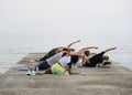 Group yoga exercises on the beach. Bulgaria.