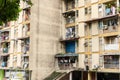 The balconies of an apartment building are hung with clothes. The poor area. Moments of Ordinary Life